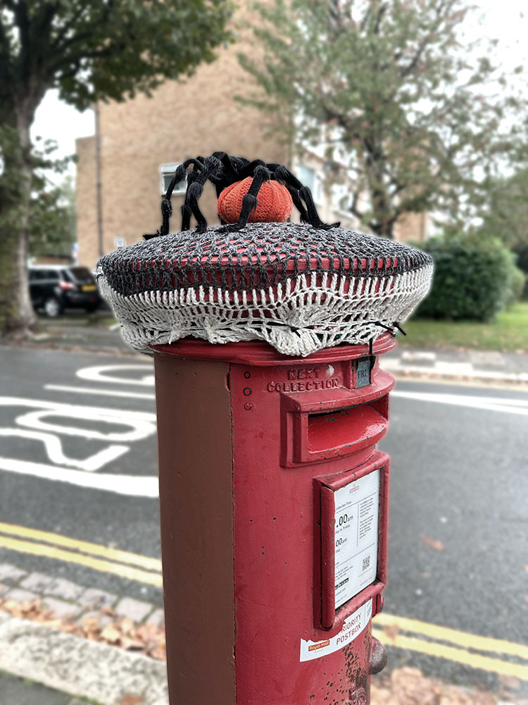 A post box with Halloween topper